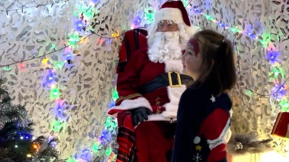 A little girl smiling in Santa's grotto