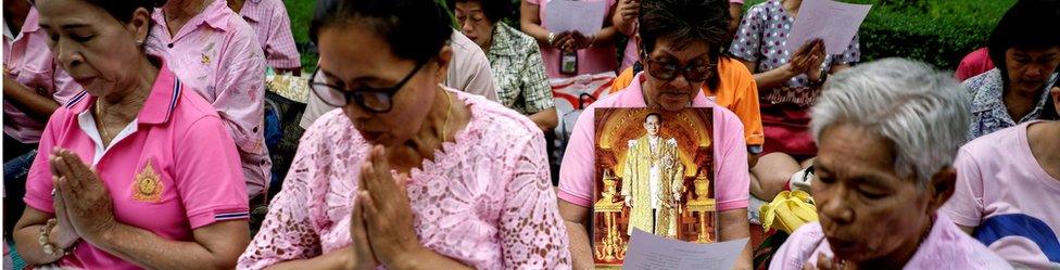 Well-wishers hold pictures of Thailand's King Bhumibol Adulyadej as they pray for him at the Siriraj hospital where he is residing in Bangkok, Thailand, 12 October 2016.