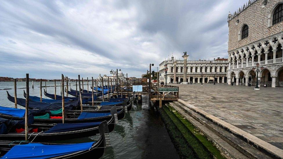 Gondolas moored at the Riva degli Schiavoni embankment by the Doge's Palace