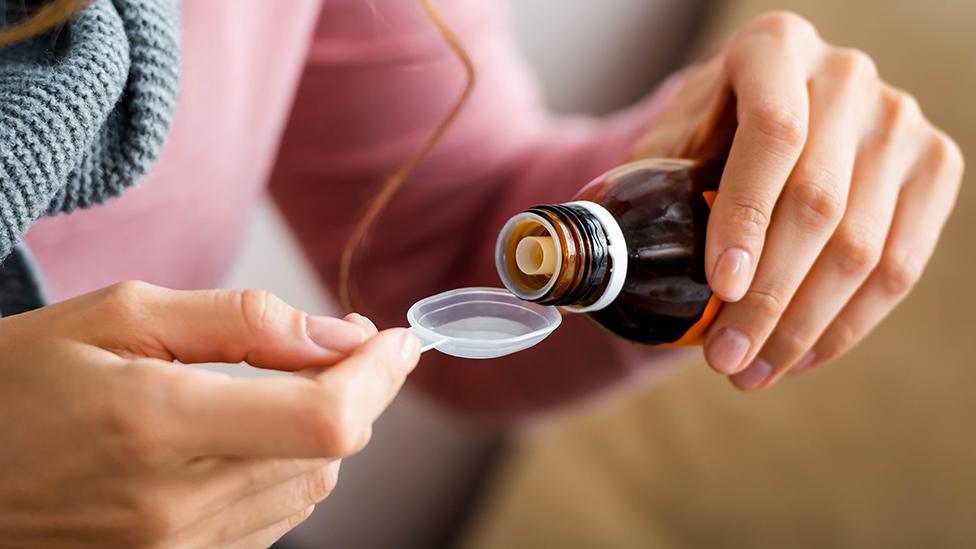 Dispensing cough syrup into spoon