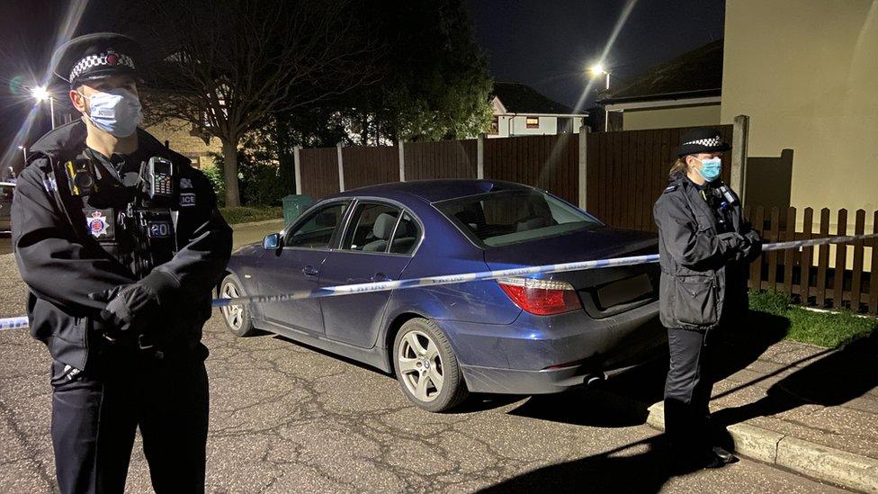 Police officers in Tennyson Road following the death of a woman