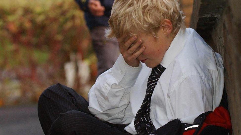 Posed photograph simulating a child being bullied bullying