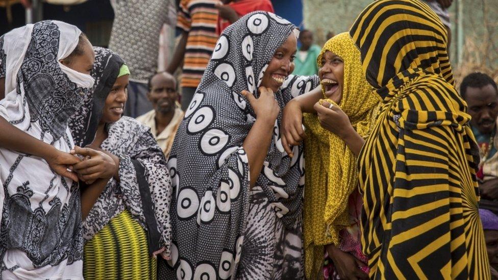 Ethiopian women chat after receiving aid distributed under a European Union (EU) funded project, in the Shinile Zone of Ethiopia Friday, April 8, 2016, near the border with Somalia.
