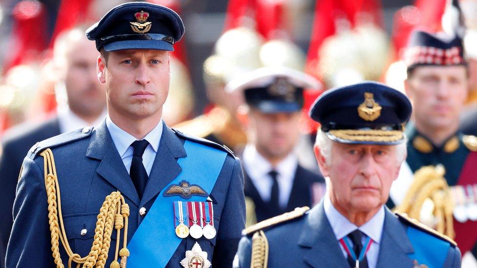 prince william and king charles walking together in uniform