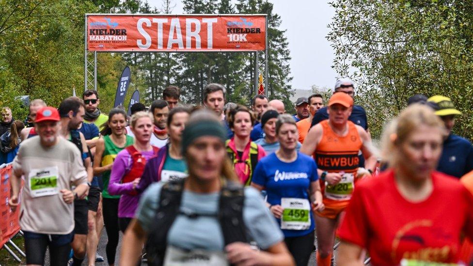 Runners with the start line behind them