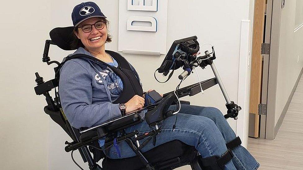 Sarah using a wheelchair smiling