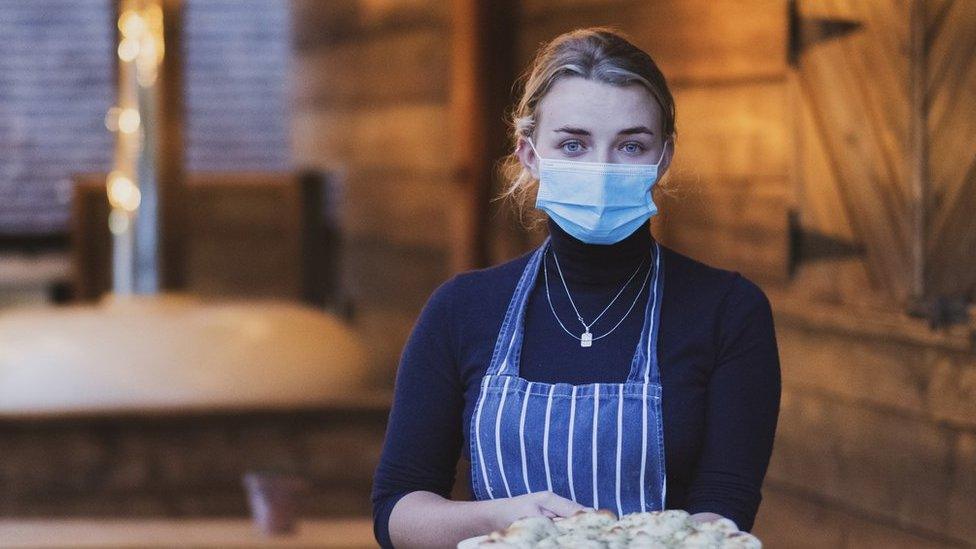 Waitress holding garlic bread