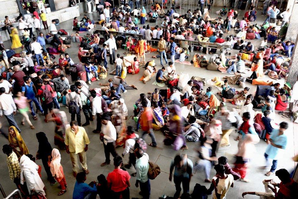 A crowd of people at the Mughalsarai station waiting for their train