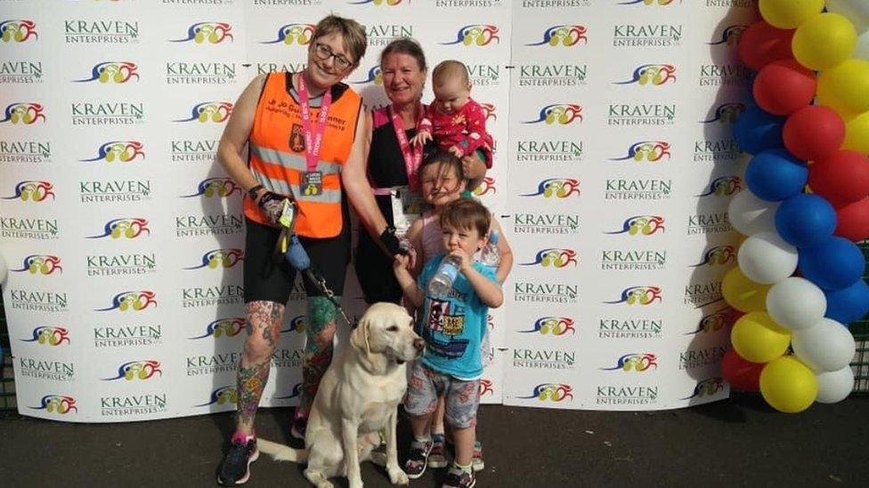 Helen McCann at the end of the London Marathon wearing her medal