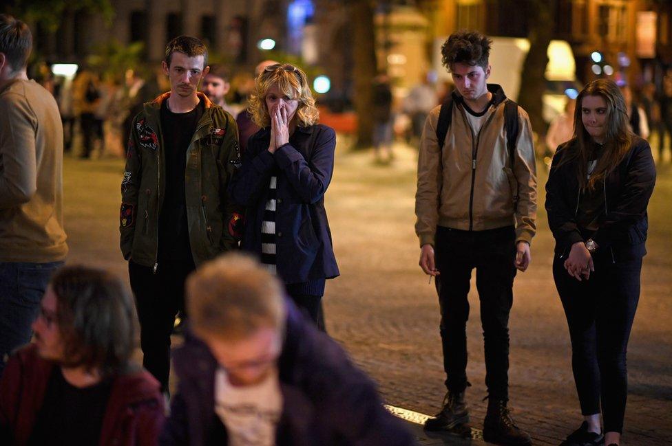 Members of the public attend a candlelit vigil in Albert Square, Manchester, 23 May