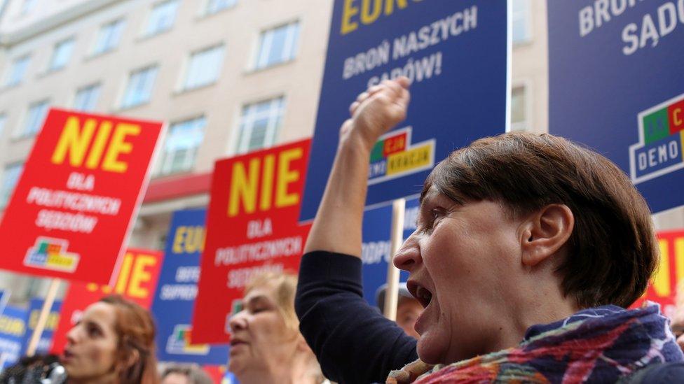 Protesters in Warsaw join a demonstration on 26 June against the Polish government's judicial reforms