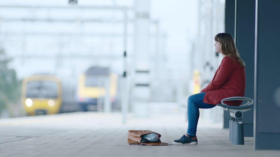 Woman sat on train platform