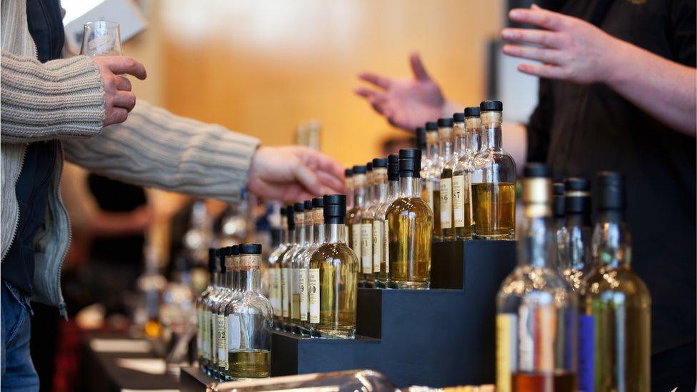 Man looking at whisky bottles