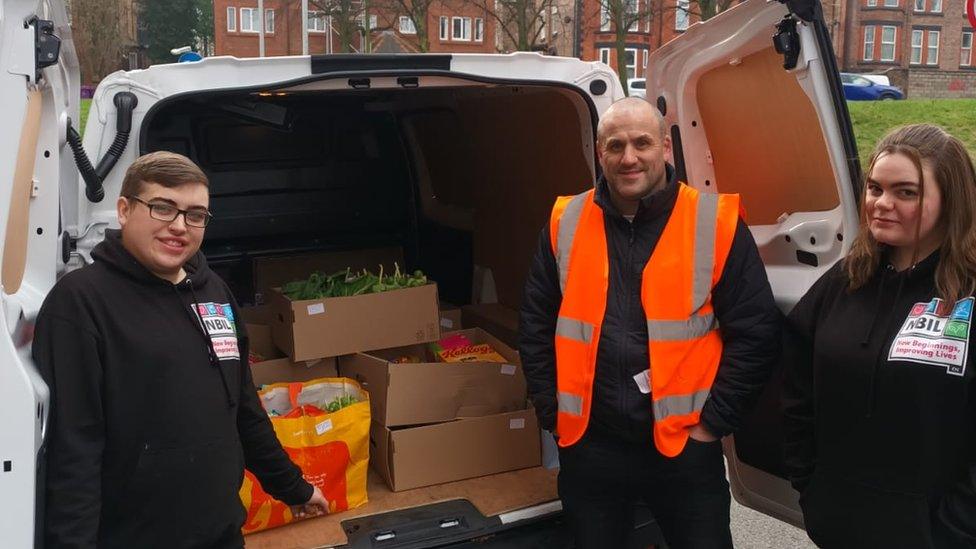 Three volunteers at delivery van