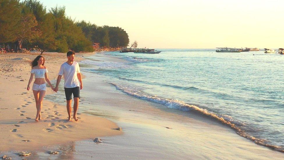 Western tourists on a beach in Bali