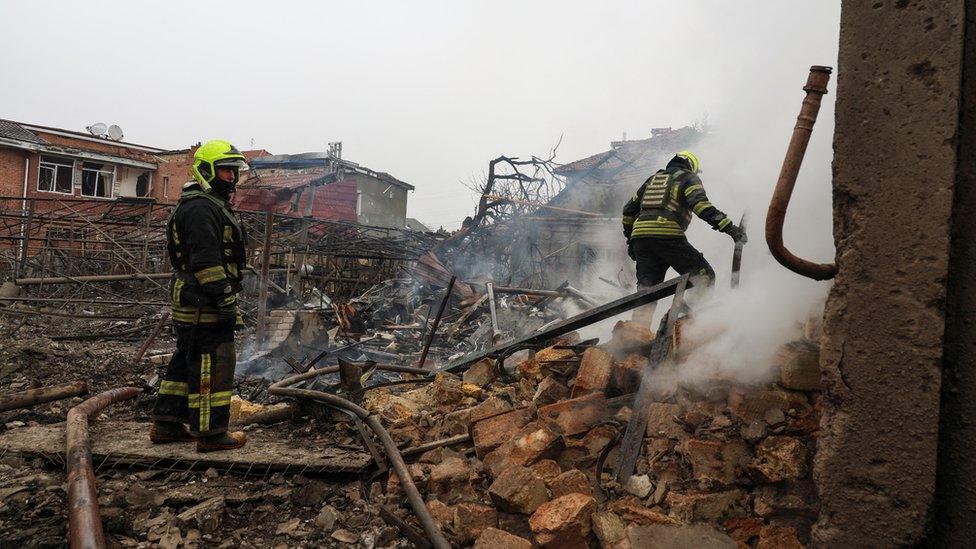 Emergency workers look through rubble after the missile strike in Odesa