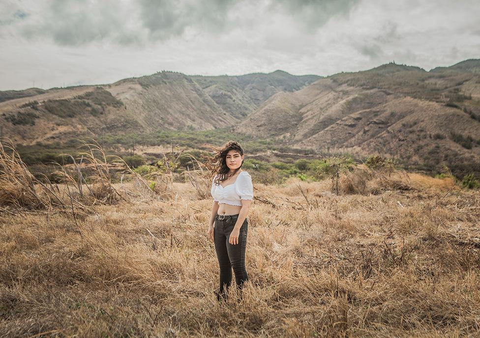 Punhele DeCosta standing in countryside