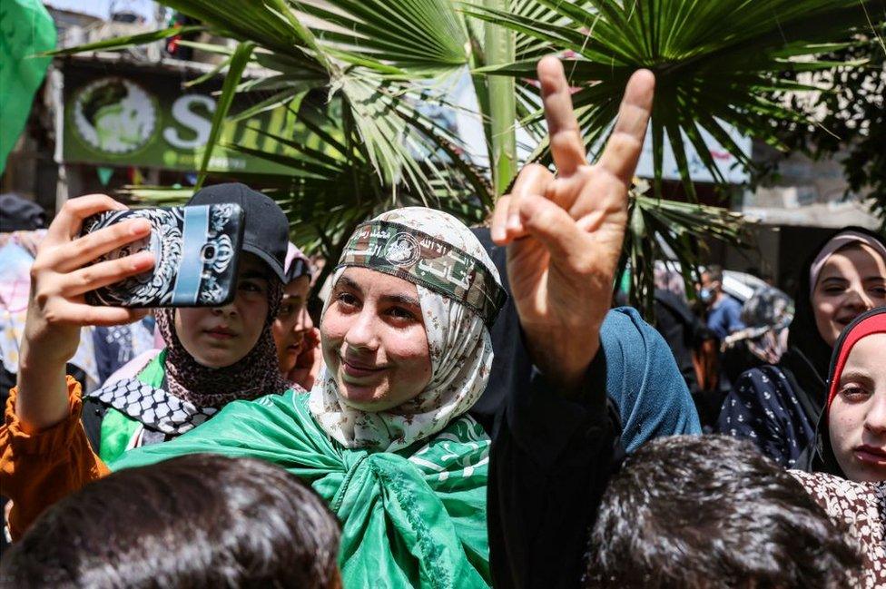 Palestinian supporters of Hamas celebrate the ceasefire between Hamas and Israel, in Khan Younis, in the southern Gaza Strip, on May 21, 2021.