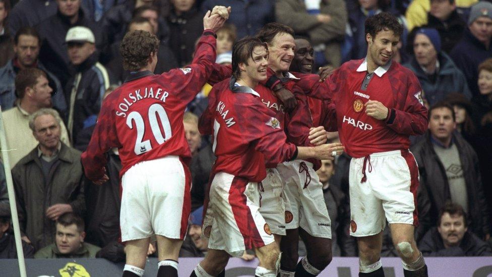 Teddy Sheringham and Andy Cole celebrate with their Manchester United team-mates