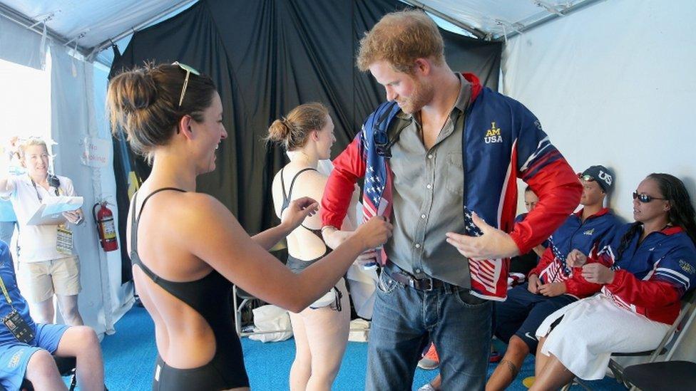 Prince Harry tries on Elizabeth Marks' jacket