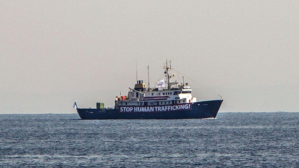 A banner that reads, "Stop Human Trafficking" is attached to the side of the C-Star as it sailed in the Mediterranean Sea