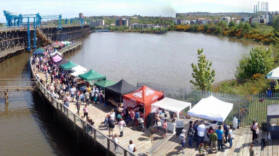 Stalls and customers line the bottom deck of Dunston Staiths for one of the monthly food markets