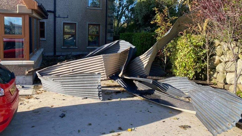 Corrugated metal strewn across a residential driveway