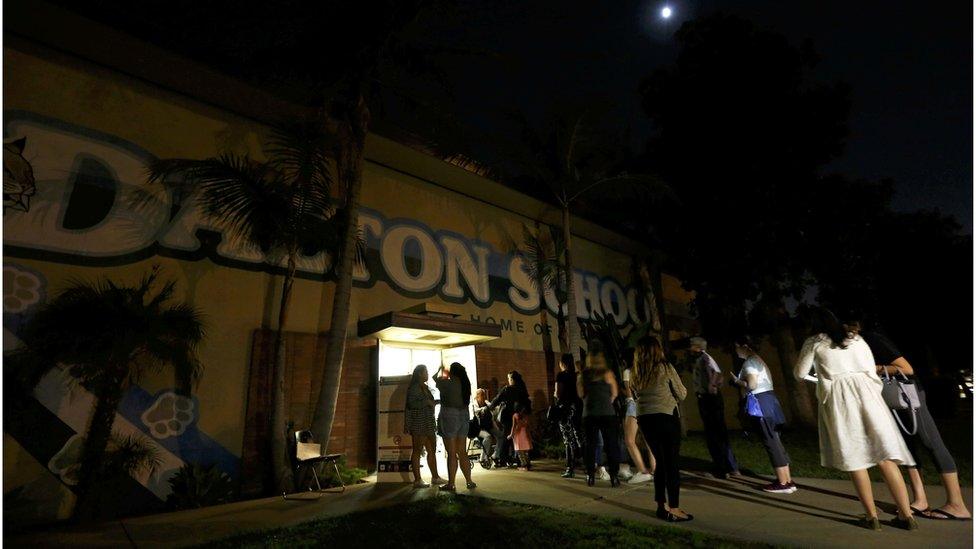 Voters gather outside Dalton Elementary School after the polling station in Azusa, California