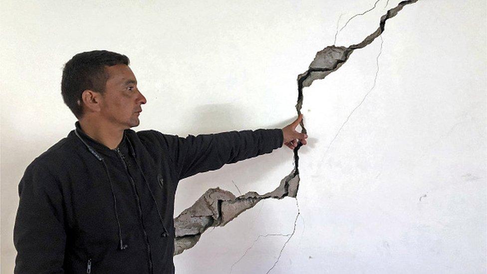 A resident shows a crack on the wall of his house at Joshimath in Chamoli district of India's Uttarakhand state on January 8, 2023