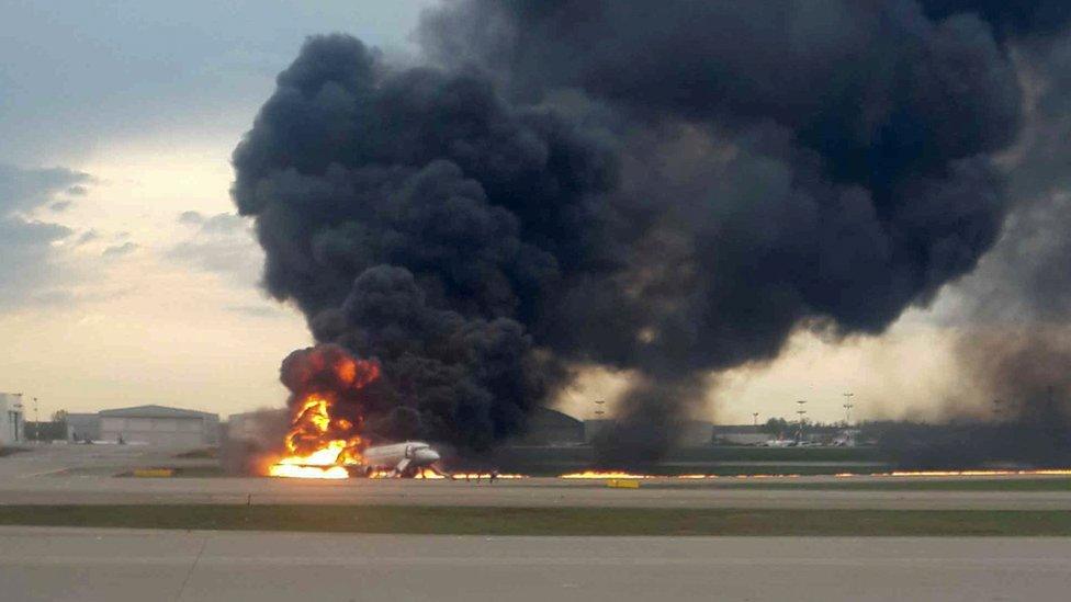 Large fire and smoke engulfs the aircraft