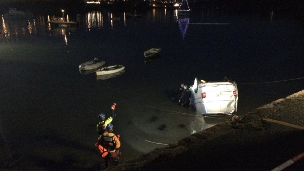 Overturned van in quay