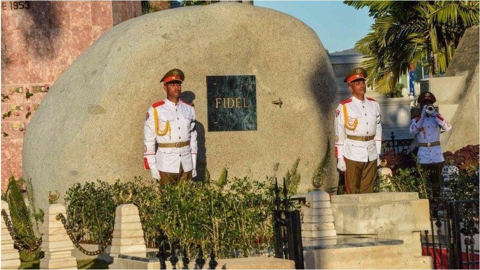 Soldiers stand guard next to a boulder where the ashes of Fidel Castro were placed.