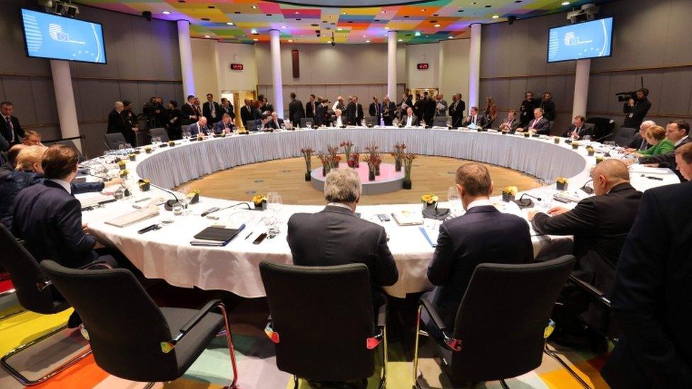 Officials attend a lunch during an informal meeting of the 27 EU heads of state or government in Brussels, sitting around circular table