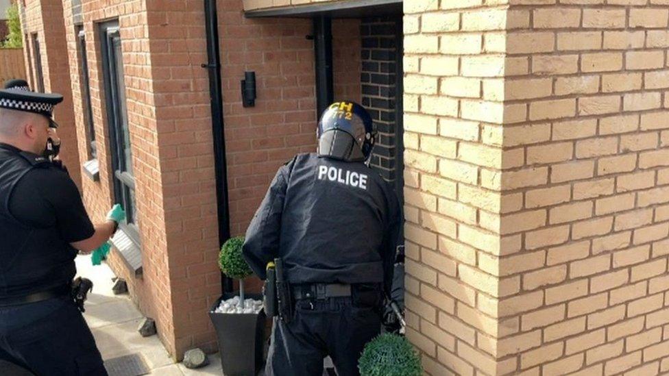Police officers raid on a house