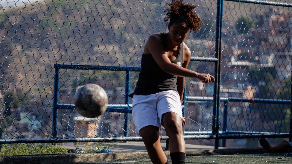 Laryssa balances on one foot at the end of her strike on goal, as the ball floats closer to the camera