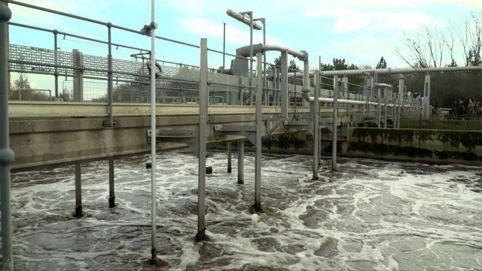 Water swirls round at a sewage works.