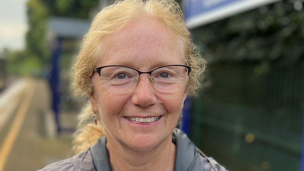 Close up of Dawn Taylor standing on the platform smiling