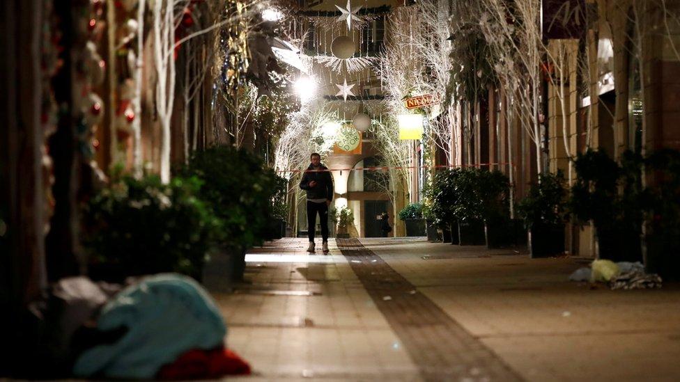 A man walks along a deserted Rue des Orfevres after a shooting in central Strasbourg, France December 12, 2018.