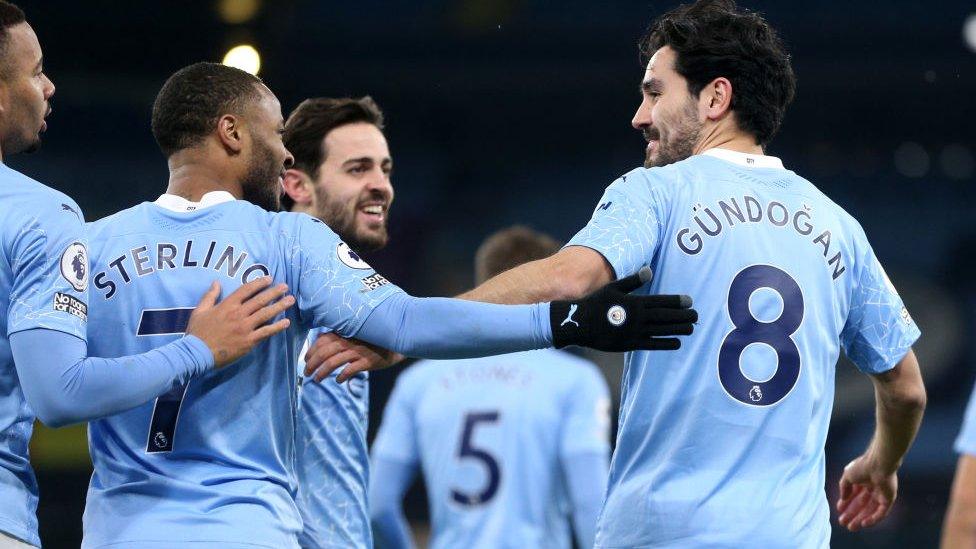 Ilkay Gundogan of Manchester City celebrates with Raheem Sterling and team mates.