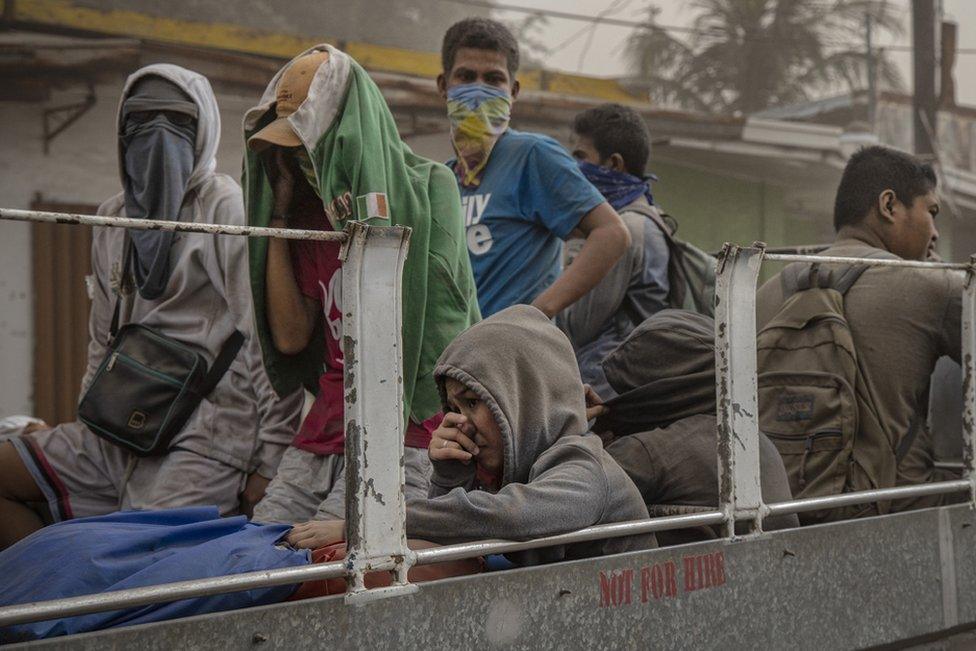 Residents fleeing Taal Volcano"s eruption ride a flatbed truck on January 13