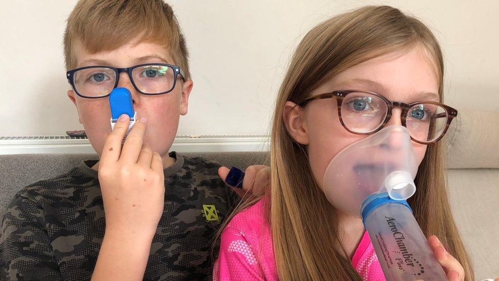 Image of brother and sister using inhalers for asthma