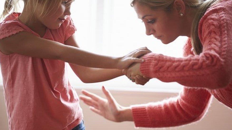 Mother hitting daughter