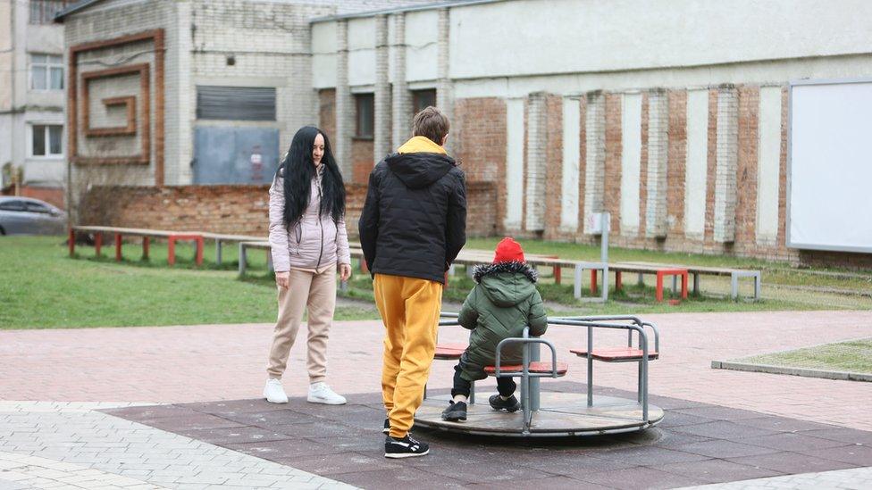 Nadia and her two sons at a playground