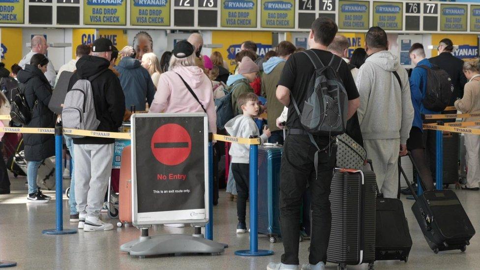 Queue of people in Stansted Airport