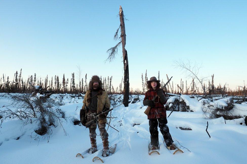 David and Sky stand on the snow