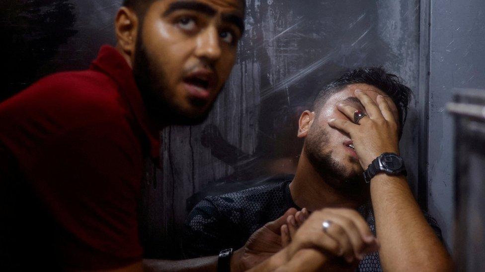 A Palestinian man reacts at a hospital in Gaza City following an explosion during a protest by the boundary wall with Israel that killed five Palestinians (13 September 2023)