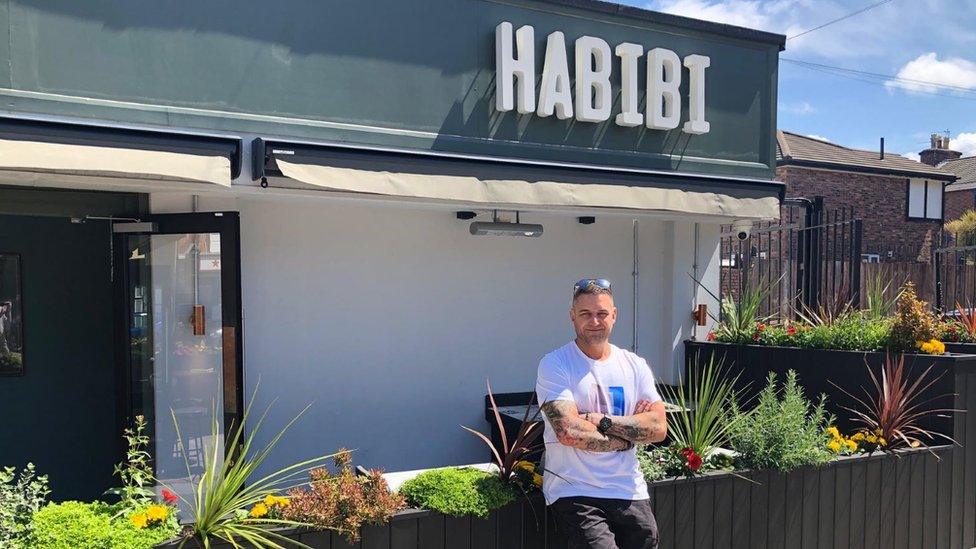 Mr Davies in front of one of the bars run by his firm