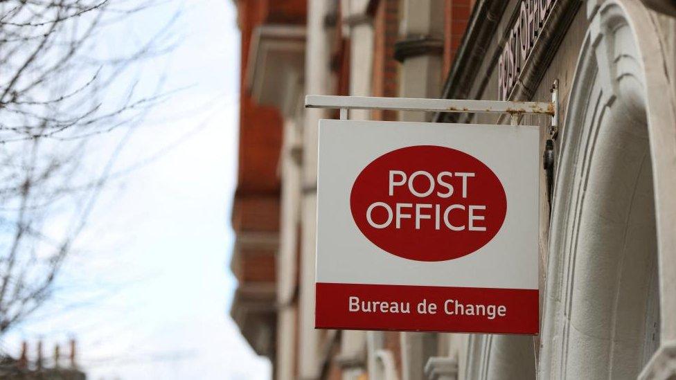 A stock image shows the outside of a branch of the Post Office