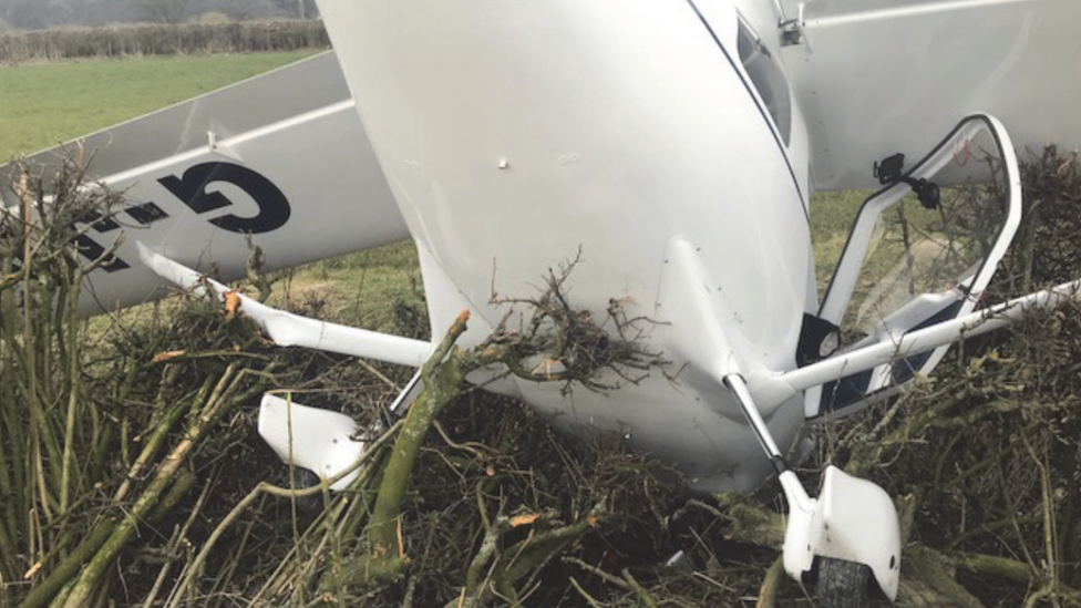 A G-JAXS light aircraft in a hedge