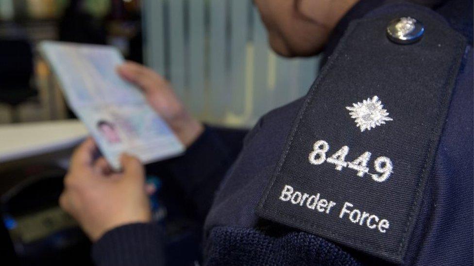 UK border official checks passport